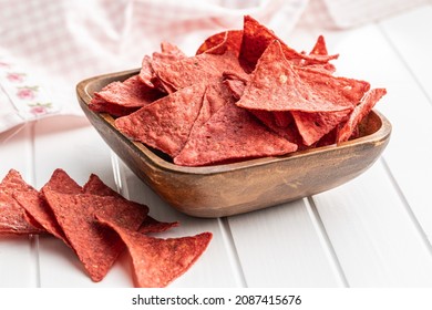 Salted Tortilla Chips Triangle With Red Beet Flavor In Bowl On White Table.