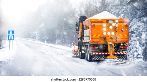 Salting Highway Maintenance. Snow Plow Truck On Snowy Road In Action. Hard Weather Condition In Winter. Gritter Vehicle Spreading Deicing Salt.