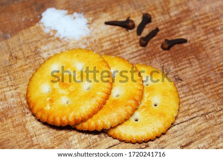 salty biscuits on wooden background with salt and Cloves