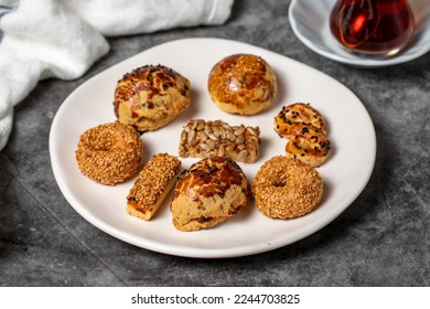 Salty cookies on a dark background. Types of cookies with sesame seeds and seeds in a plate. close up