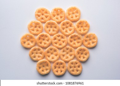 Salty fried wheel snack arranged over white background creating pattern

