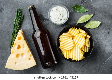 Salty Potato Chips Snack Set With Cheese And Onion, With Dipping Sauces, And Bottle Of Beer, On Gray Stone Background, Top View Flat Lay