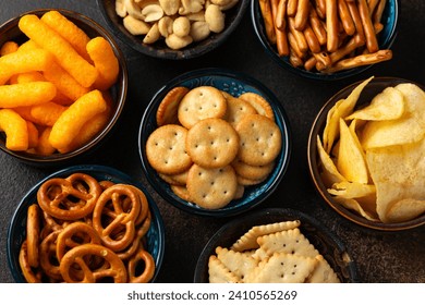 Salty snacks crackers, potato chips, pretzel, peanuts corn puffs - Powered by Shutterstock