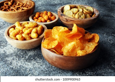 Salty Snacks. Pretzels, Chips, Crackers In Wooden Bowls.