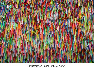Salvador, Bahia, Brazil - 03 13 2022: Colorful ribbons tied to a wall symbolizing the wishes and requests of the devotees of Senhor do Bonfim, Bahia, Brazil