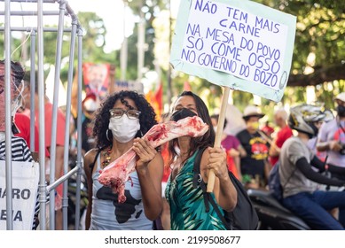 Salvador, Bahia, Brazil - April 09, 2022: A Woman Protesting Against Far-right Presidential Candidate Jair Bolsonaro, With Bovine Bone In Her Hands Symbolizing Hunger.