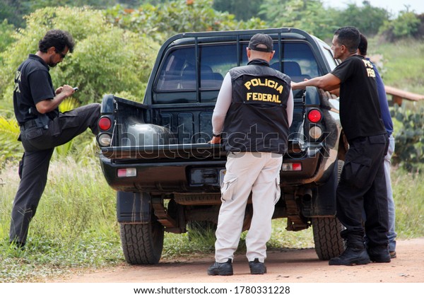 salvador,
bahia / brazil - april 15, 2014: agents of the Federal Police of
Brazil are seen during an action in operation aimed at repressing
clandestine extraction of sand in
Camacari.