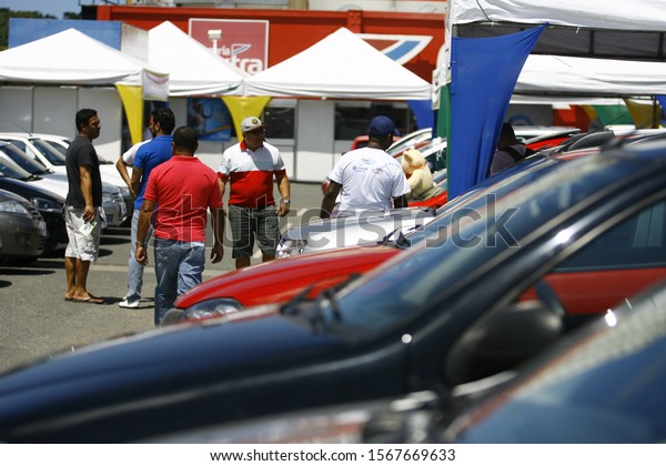 SALVADOR, BAHIA / BRAZIL - August 29, 2014:\
Customers are seen during used vehicle fair. The event takes place\
in the parking lot of the Extra supermarket on Avenida Luiz Viana\
in Salvador (BA).