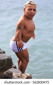 SALVADOR, BAHIA, BRAZIL - DEC 18, 2016: Celebrity midget diving and swimming  at Porto da Barra Beach