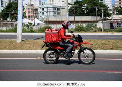 Salvador, Bahia, Brazil - December 18, 2020: Delivery Of Food By Application Is Seen Using A Motorcycle In The Pituba Neighborhood, In The City Of Salvador.