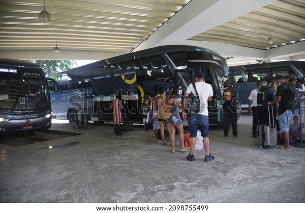 salvador,\
bahia, brazil - december 28, 2021: passengers while boarding an\
intercity bus at Salvador city bus\
station.