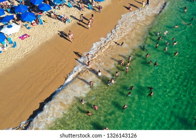 SALVADOR, BAHIA, BRAZIL - FEB 26, 2019: Porto Da Barra Beach, People Swimming On A Beautiful Emerald Green Water. 