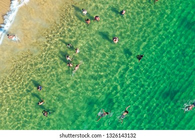 SALVADOR, BAHIA, BRAZIL - FEB 26, 2019: Porto Da Barra Beach, People Swimming On A Beautiful Emerald Green Water. 