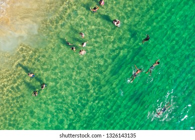 SALVADOR, BAHIA, BRAZIL - FEB 26, 2019: Porto Da Barra Beach, People Swimming On A Beautiful Emerald Green Water. 