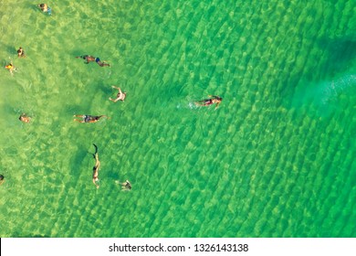 SALVADOR, BAHIA, BRAZIL - FEB 26, 2019: Porto Da Barra Beach, People Swimming On A Beautiful Emerald Green Water. 