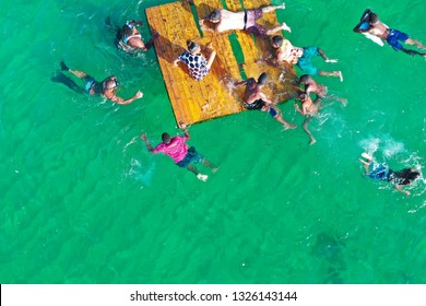 SALVADOR, BAHIA, BRAZIL - FEB 26, 2019: Porto Da Barra Beach, People Swimming On A Beautiful Emerald Green Water. 