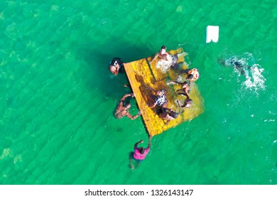 SALVADOR, BAHIA, BRAZIL - FEB 26, 2019: Porto Da Barra Beach, People Swimming On A Beautiful Emerald Green Water. 