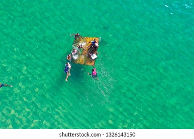 SALVADOR, BAHIA, BRAZIL - FEB 26, 2019: Porto Da Barra Beach, People Swimming On A Beautiful Emerald Green Water. 