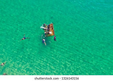 SALVADOR, BAHIA, BRAZIL - FEB 26, 2019: Porto Da Barra Beach, People Swimming On A Beautiful Emerald Green Water. 