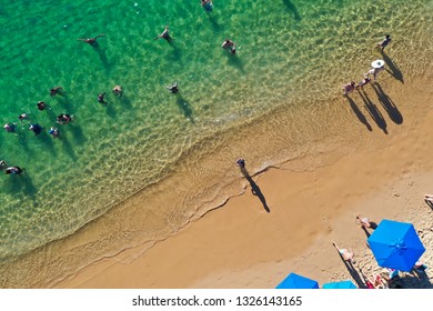 SALVADOR, BAHIA, BRAZIL - FEB 26, 2019: Porto Da Barra Beach, People Swimming On A Beautiful Emerald Green Water. 