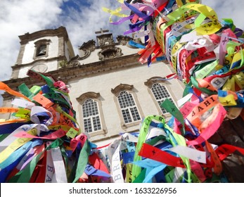 Salvador, Bahia / Brazil - February 11 2013: Fitas do Senhor do Bonfim (colored wish ribbon) tied to the gates of Igreja Nosso Senhor do Bonfim (catholic church) in Salvador, Bahia, Brazil.