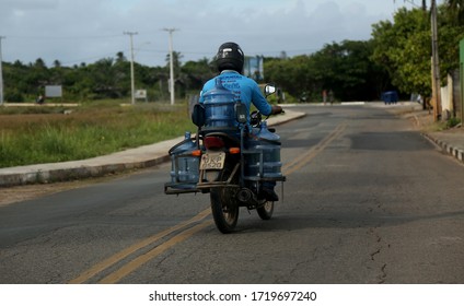 salvador, bahia / brazil - january 22, 2015: delivery of mineral water on a motorcycle, seen on Avenida Luiz Viana, in the city of Salvador.