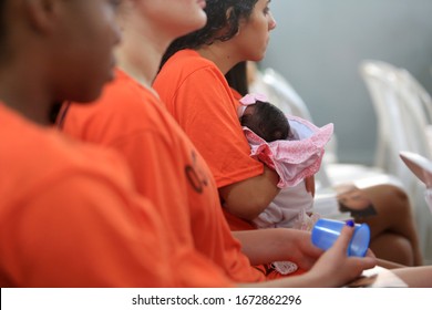 Salvador, Bahia / Brazil - July 25, 2016: Inmate Of The Female Presidio Of Salvador Holds Her Son During An Event In The Prison Unit.