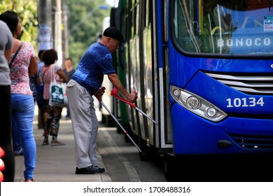 Salvador, Bahia / Brazil - July 8, 2016: Elderly Man With Limited Mobility Taking A Bus At A Bus Stop On Avenida Tancredo Neves In The City Of Salvador.




