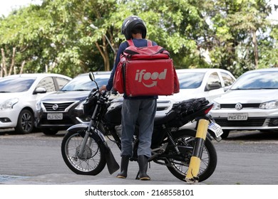 Salvador, Bahia, Brazil - June 13, 2022: Motorcyclist Who Delivers Food By App Is Seen Next To His Motorcycle In The City Of Salvador.