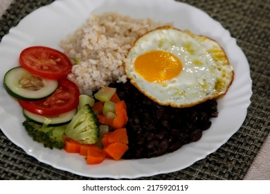 Salvador, Bahia, Brazil - June 3, 2022: Food Plate With Black Beans, Rice Salad And Fried Egg.