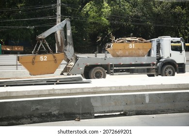 Salvador, Bahia, Brazil - November 10, 2021: Truck Is Seen Placing Metal Bucket For Construction Waste Collection In A Street In Salvador City.