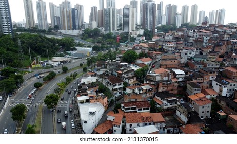 salvador, bahia, brazil - november 20, 2021: aerial view of traffic lanes and housing area in favela in Salvador city.