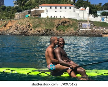 SALVADOR, BRAZIL - FEB 26, 2017: Black Gay Couple On A Stand Up Board Paddling , Porto Da Barra Beach.