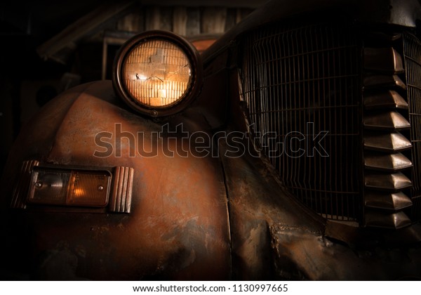 Salvage Title Junk Car. Old and Rusty Classic Car\
in the Barn. Closeup\
Photo.