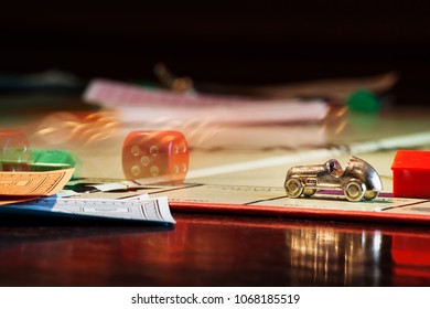 Salzburg, Austria - April 6 2010: Monopoly Boardgame With Rolling Dice Behind Car