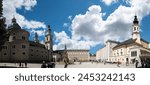 Salzburg, Austria, August 15, 2022. Large format panoramic photo of the Residenzplatz square, the largest. In the center is the beautiful fountain with statues of prancing horses. People walk.