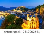 Salzburg, Austria: Night view of the historic city of Salzburg with famous Festung Hohensalzburg and Salzach river illuminated in beautiful twilight autumn scenic