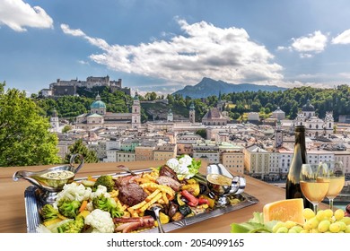 Salzburg City With Gastronomic Experience Of Typical Austrian Food And Wine Against Downtown In Austria