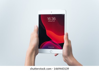 Samara, Russia -07, 29, 2019: Teenage Boy Holding IPad Air With Beta Ipados 13 On White Background. The Main Menu Of The IPad In The Hands Of A Young Man.