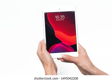 Samara, Russia -07, 29, 2019: Teenage Boy Holding IPad Air With Beta Ipados 13 On White Background. The Main Menu Of The IPad In The Hands Of A Young Man.