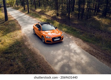 Samara, Russia - 09.05.2020: Orange AUDI A5 S Line. A Modern Sports Orange Car Is Parked On A Forest Road. Travel Concept. Pine Forest At The Sunset. Bird's-eye View