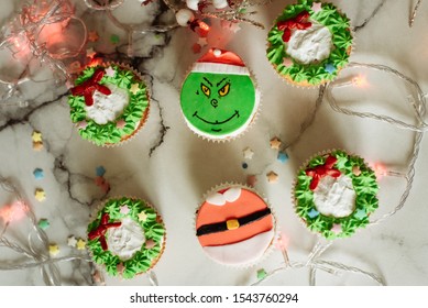 Samara, Russia - 7.10.2019: Christmas Cupcakes Decorated With Cream And Made In The Form Of A Grinch Who Stole Christmas.