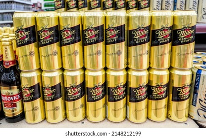 Samara, Russia - April 19, 2022: Miller alcoholic canned beer on the shelf in a  superstore. Various alcoholic beverages and spirit drinks. Selective focus