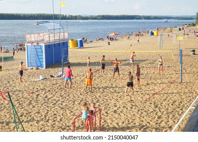 Samara, Russia - circa January, 2022: A group of people playing beach volleyball on the sand