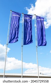 Samara, Russia - July 2, 2021: Volvo dealership flags over blue sky. Volvo is a Swedish multinational automaker company 