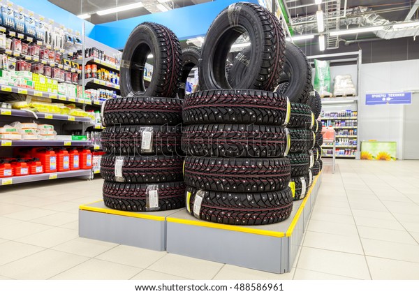 SAMARA, RUSSIA - SEPTEMBER\
24, 2016: Brand new winter tires stacked up for sale in the\
hypermarket Lenta