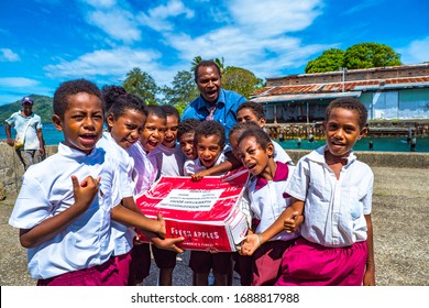 Samari Island, Milne Bay, Papua New Guinea - March 9th 2020 - Local school children on tropical island receiving school book donation