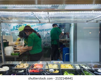 Samarinda, Indonesia - March 04, 2022 : The employees preparing and cleaning the kitchen before opening the store