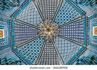 Samarkand, Uzbekistan - May 11 2021: Details of vaulting with Eastern ornaments. Medieval mausoleum of Qutham ibn Abbas of XIV century in historical complex Shah-i Zinda