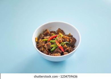 Sambal Goreng Ati In White Bowl With Light Blue Background